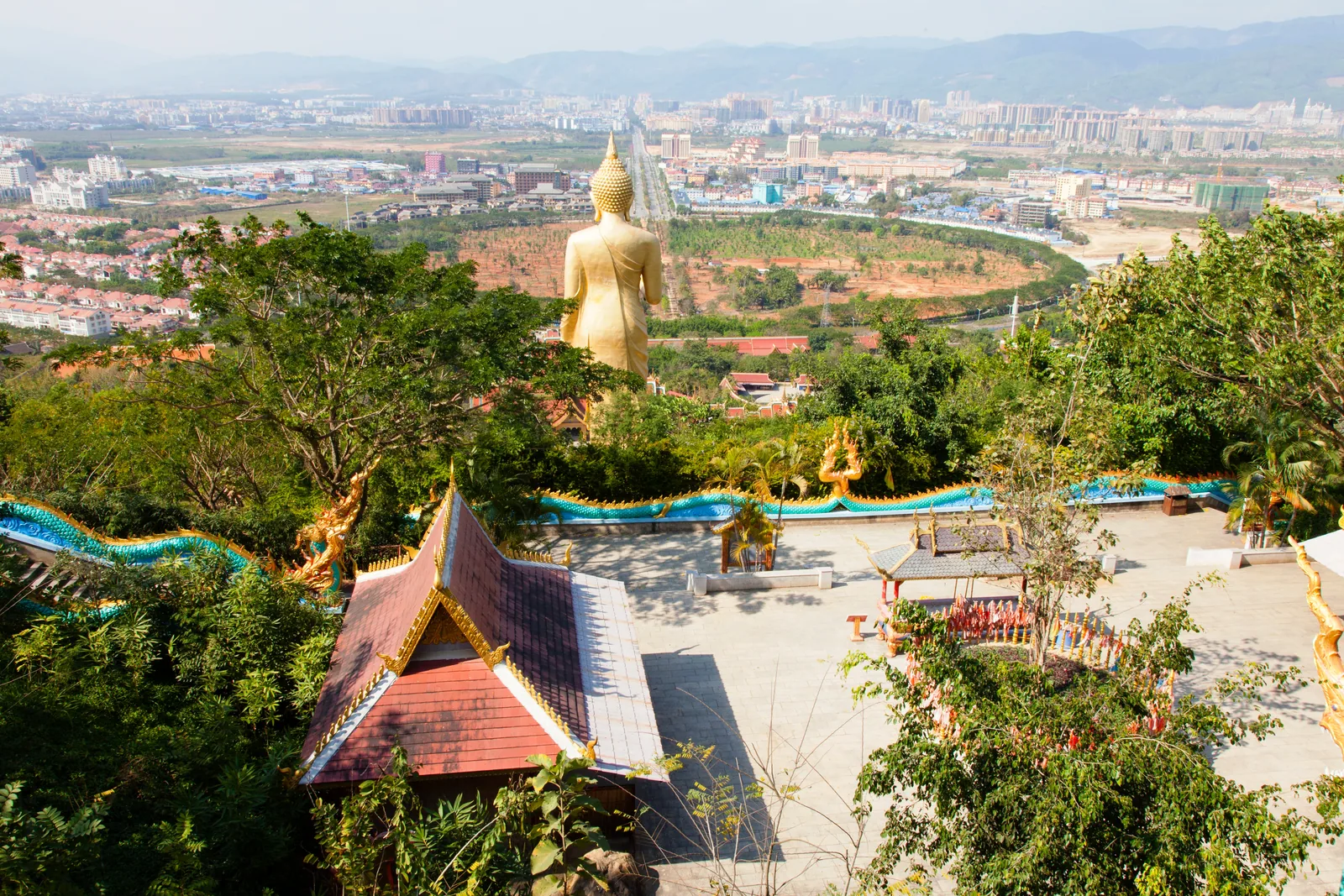 Golden Buddha statue above Jinghong and the surrounding hills in Xishuangbanna