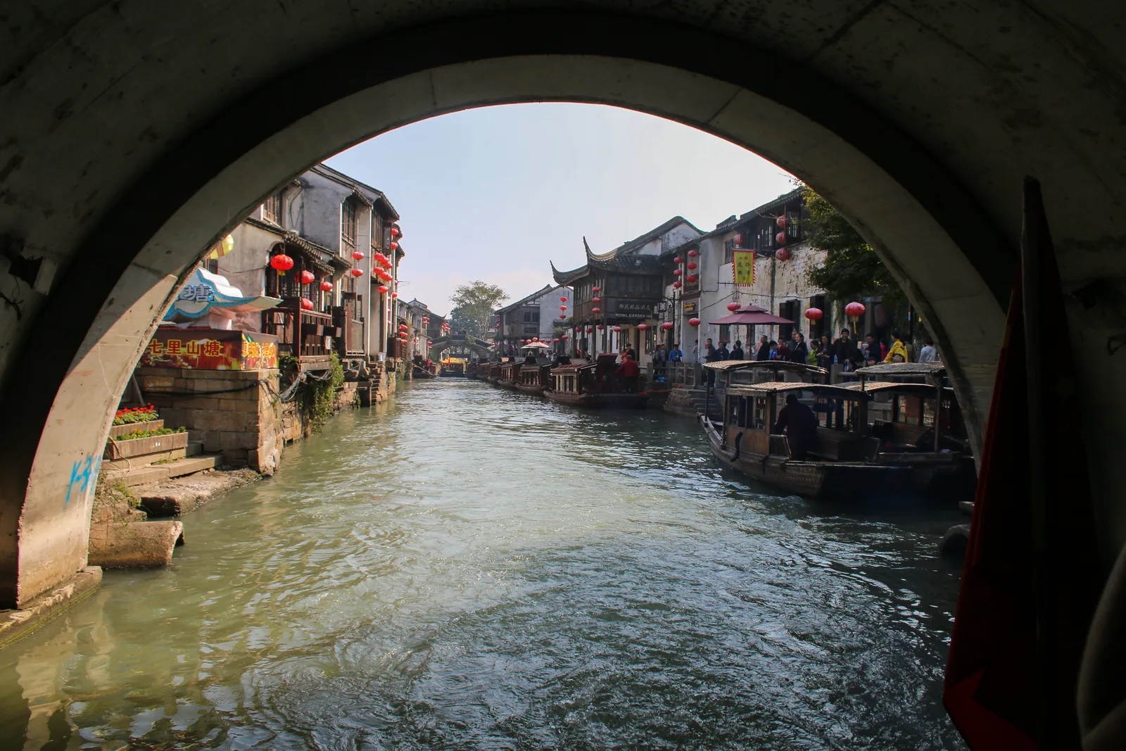 Suzhou canal and waterside houses seen beneath a stone bridge